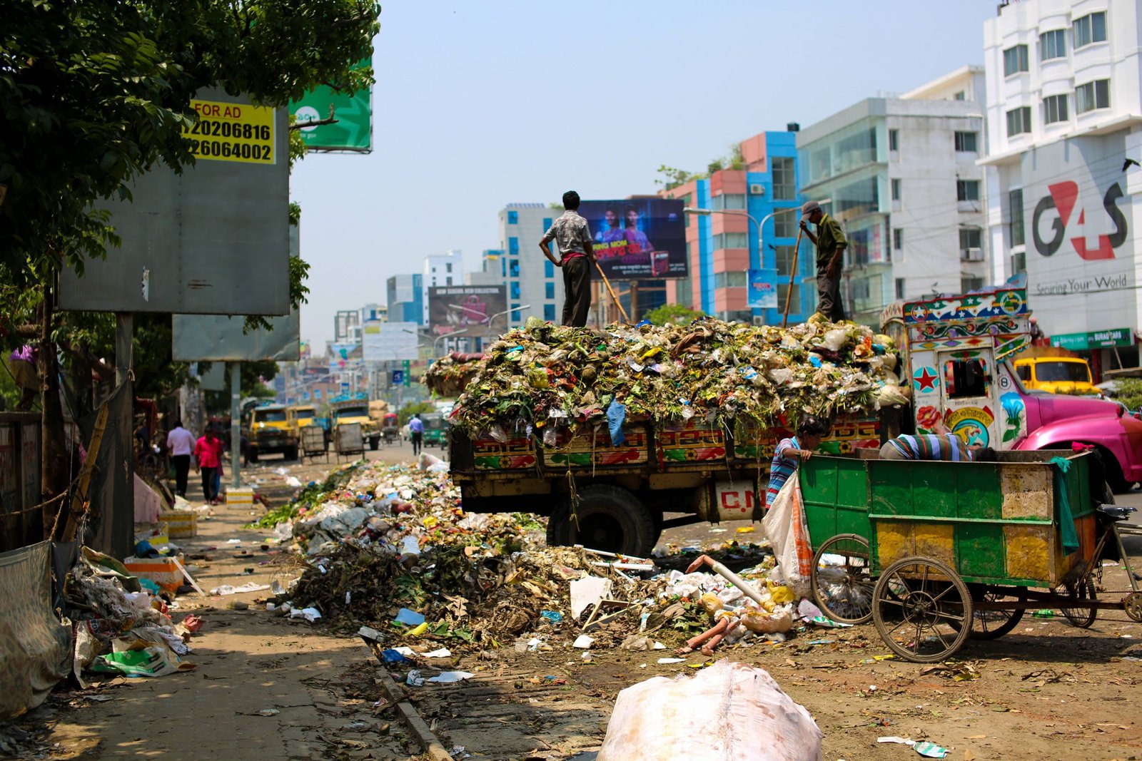 picture of a trash truck and a lot of trash in india