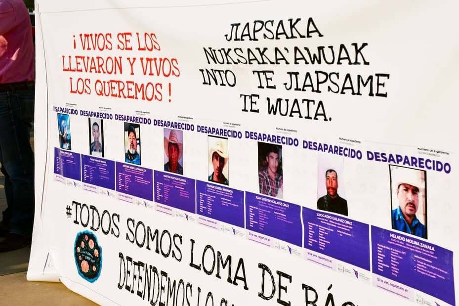 A LOCAL BANNER SHOWING THE PHOTOS OF EIGHT MEMBERS OF THE YAQUI INDIGENOUS COMMUNITY IN SONORA, MEXICO, WHO WENT MISSING IN JULY 2021. KENDAL BLUST/KJZZ
