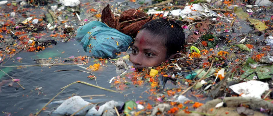 a boy swimming in Ganges river underwater