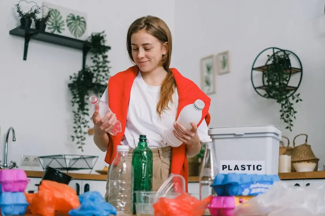 a woman recycling bottles 